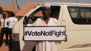 Supporter holding a #VoteNotFight sign